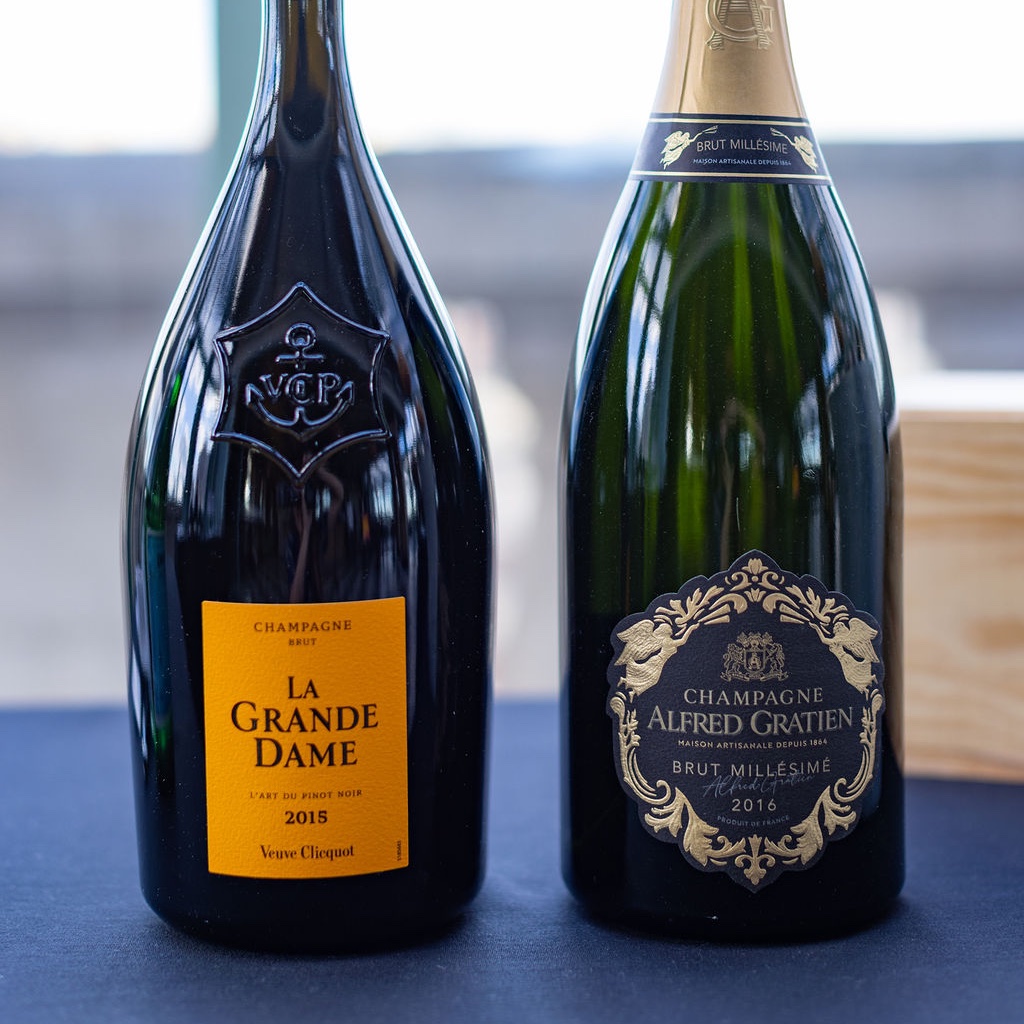 Labels of La Grande Dame 2015 and Alfred Gratien 2016 Champagne bottles.