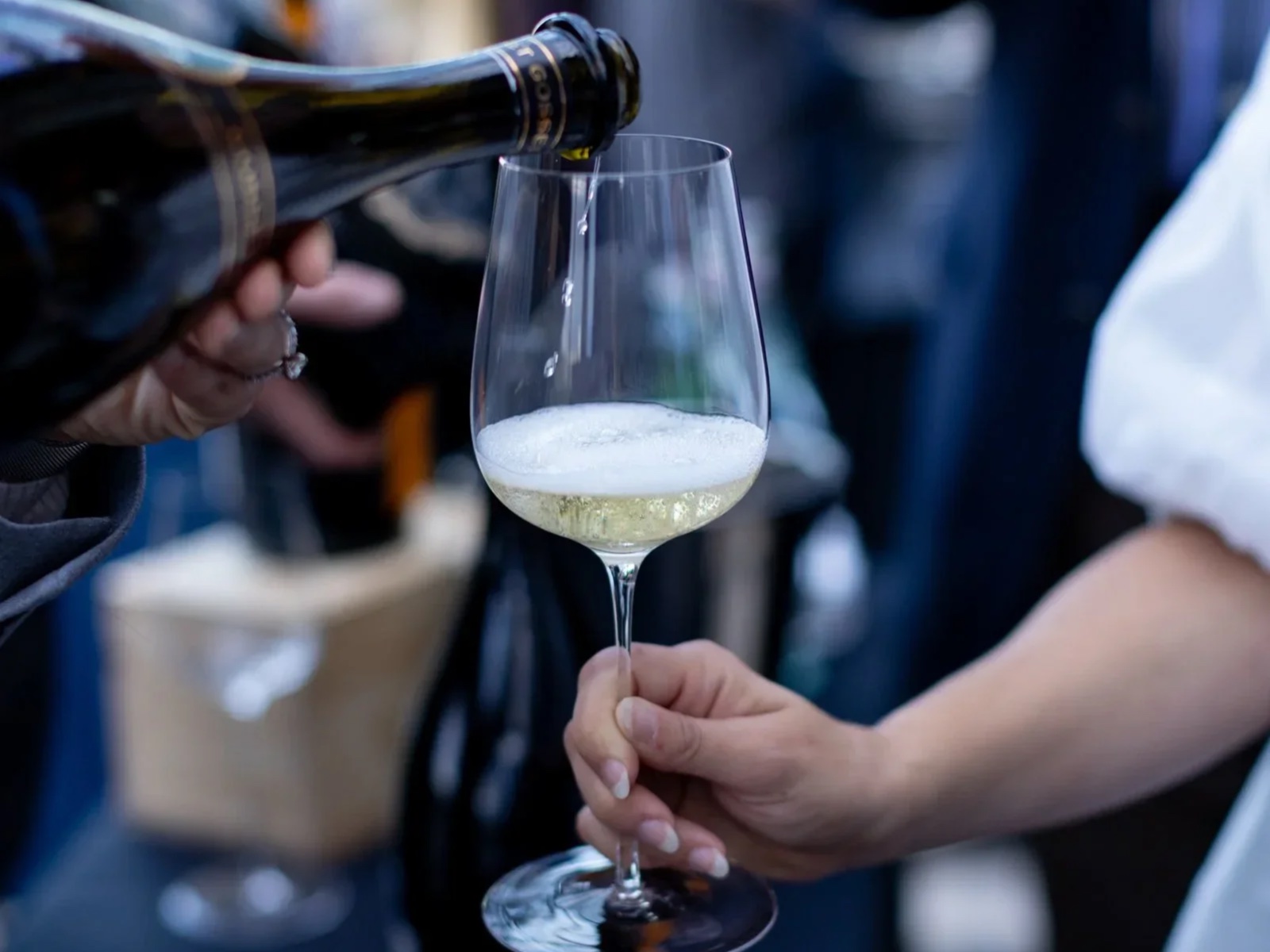 Champagne being poured into a guest’s tasting glass.