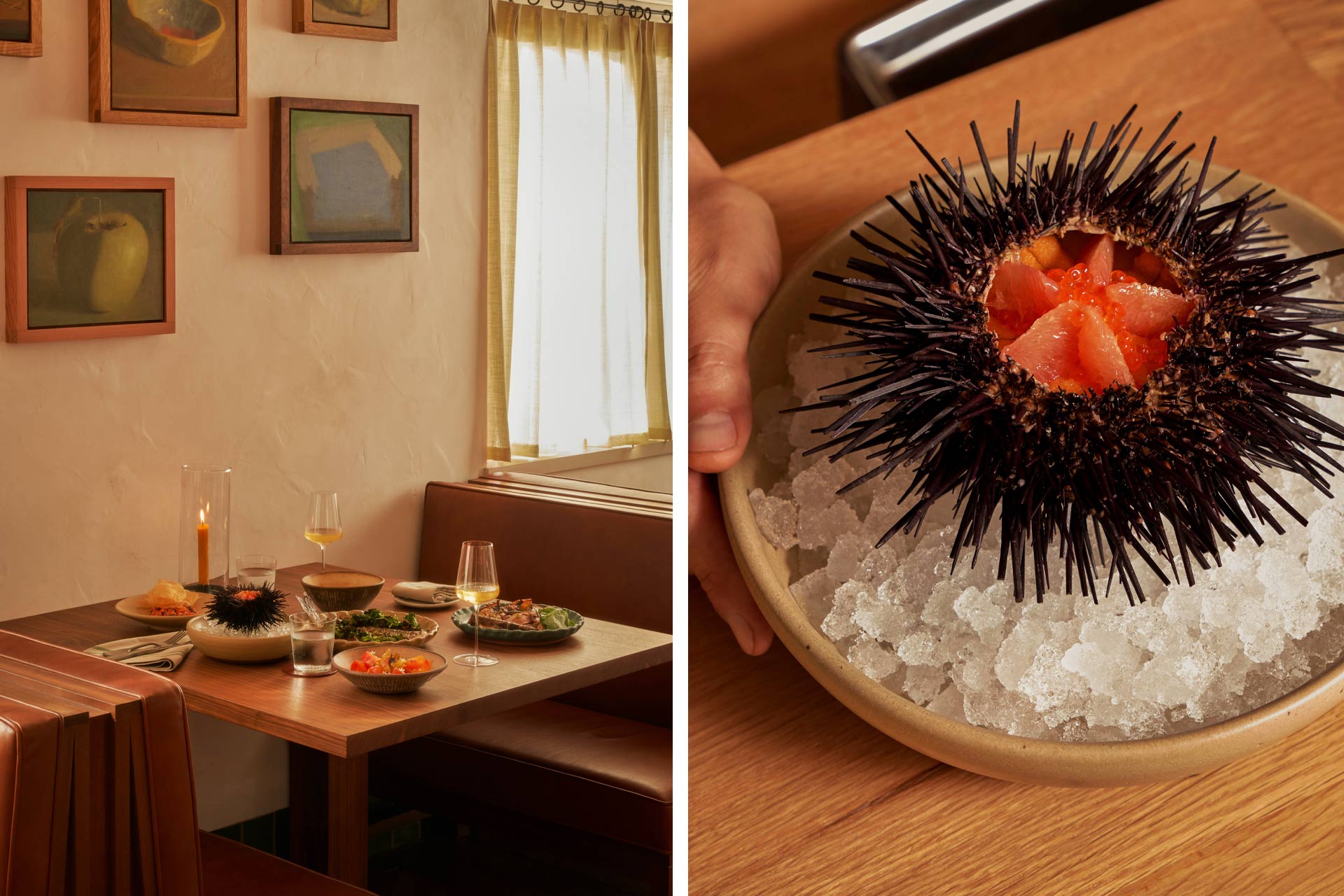 Sea urchin served on ice in a wooden bowl at a fine dining table with wine glasses and plated dishes