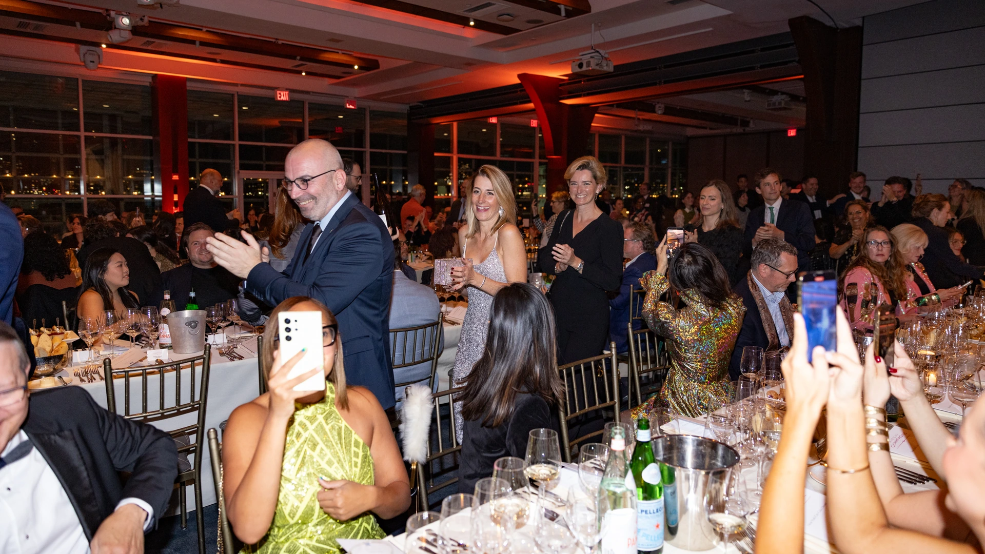 Guests celebrating around tables at the 2025 New York La Fête du Champagne Gala Dinner.
