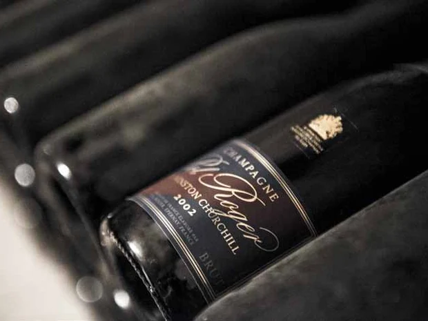 Pol Roger Cuvée Sir Winston Churchill 2002 resting among bottles in the cellar.